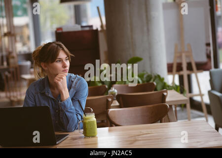 Beautiful woman sitting with laptop in the cafe Stock Photo