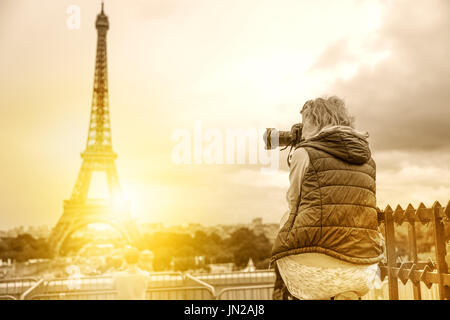 Professional photographer with camera on Place du Trocadero. Traveler woman in Paris, France, Europe. Eiffel Tower on background. Travel and tourism c Stock Photo