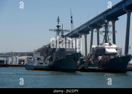 US Navy ships docked in San Diego Bay, under the Coronade Bridge. Stock Photo