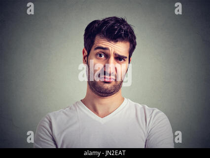 frowning man thinking expressing doubts and concerns Stock Photo