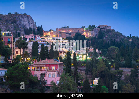 Sicily town, view of the scenic hillside town of Taormina at night with the ancient Greek theatre illuminated on the skyline, Sicily. Stock Photo