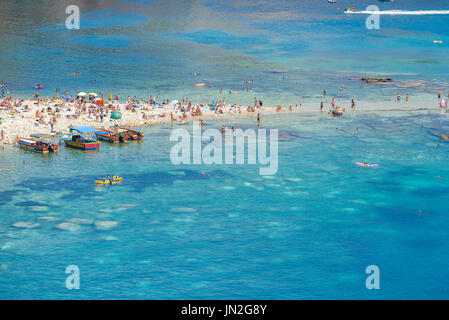 Italy beach Sicily, view in summer of Mazzaro beach, a popular sunbathing beach below Taormina in Sicily, Sicilia, Italy Stock Photo