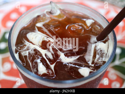 Iced black coffee with many ice cubes, selective focus with blurred background Stock Photo