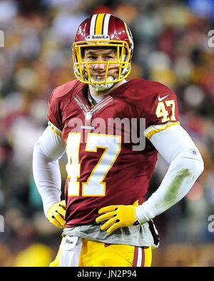 Washington Redskins Chris Cooley, with a No. 21 on his jersey, catches a  short pass and is tackled by Bills linebacker Keith Ellison during the 2nd  quarter of game on December 2