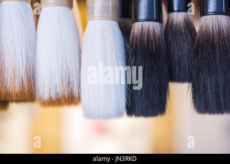 Traditional Chinese calligraphy brushes hanging in a shop Stock Photo