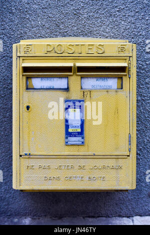 Yellow French Post Box in Bourges, France. Labeled "Posts" it asks not to throw newspapers into the box. Stock Photo