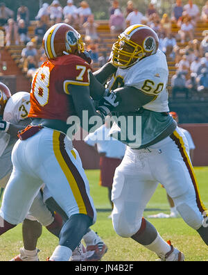 Washington Redskins linebacker Shawn Barber (59), defensive end Bruce Smith  (78), defensive tackle Dana Stubblefield (94) and linebacker Derek Smith  (50) during a break in the action in the game against the