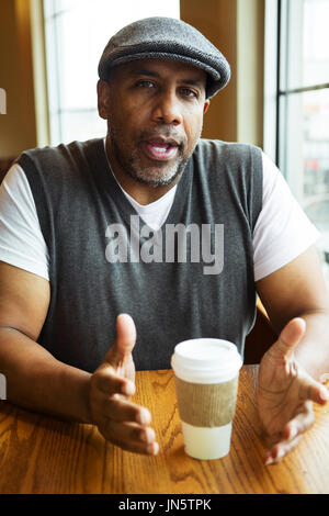 Mature African American man sitting in a coffee shop. Stock Photo