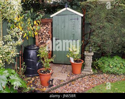 English back garden in Autumn with shed and log store Stock Photo