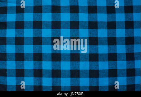 blue checked fabric tablecloth. blue-black cloth in a cage in the background Stock Photo