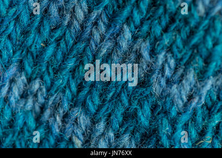 A beautiful closeup of a hand knitted warm and soft wool pattern. Soft socks or scarf of natural wool. Colorful pattern. Stock Photo