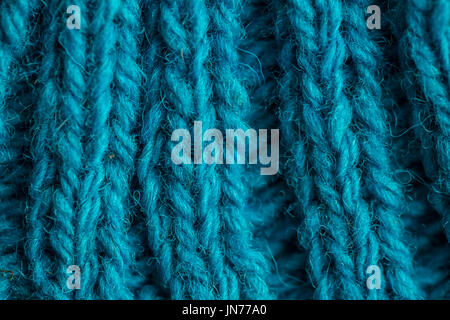 A beautiful closeup of a hand knitted warm and soft wool pattern. Soft socks or scarf of natural wool. Colorful pattern. Stock Photo