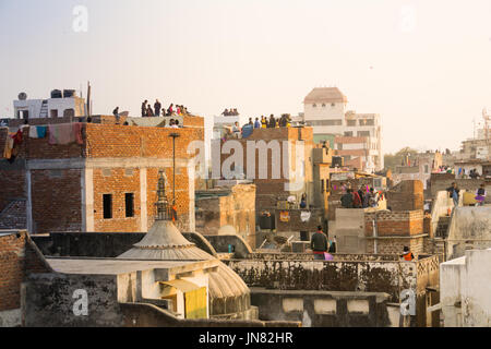 Jaipur, India - 14th Jan 2017 : Families flying kites from the rooftops of their old brick buildings in the old city of Jaipur. This is a popular sport of Makar Sankranti and Independence Day. Stock Photo