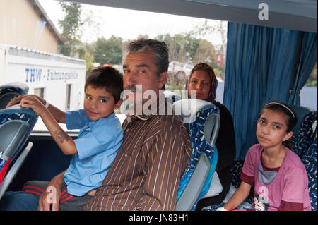 Passau, Germany - August 1, 2015: Refugees from Syria in the bus on the way to Passau. They are seeking asylum in Europe after fleeing from civil war. Stock Photo