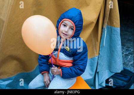 Munich, Germany -September 7th, 2015: Refugee child from Syria with a balloon at the registration camp. The boy arrived after fleeing from civil war. Stock Photo