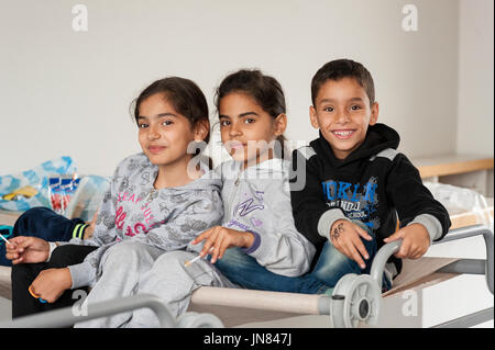 Passau, Germany - August 2th, 2015: Three sisters from Syria at a refugee camp in Passau, Germany. The refugee children are seeking asylum in Europe. Stock Photo