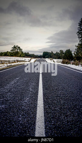 OHAKUNE, NEW ZEALAND - Icy roads through the quiet countryside of Ohakune. Many people snowboard/ski of the famous Mt Ruapheu Mountain close to here. Stock Photo