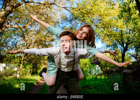 Portrait of happy couple raising their hands in open air. Stock Photo
