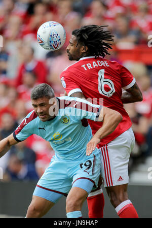 Burnley's Jonathan Walters (left) and Nottingham Forest's Armand Traore challenge during the pre-season match at The City Ground, Nottingham. Stock Photo