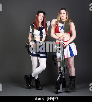 Twin cosplay sisters with airsoft guns Stock Photo