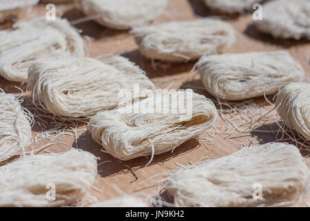 closeup of dry noodles drying in the sun Stock Photo
