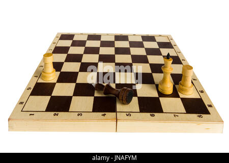 Endgame. The black chess king is defeated and lies on the board. Stock Photo