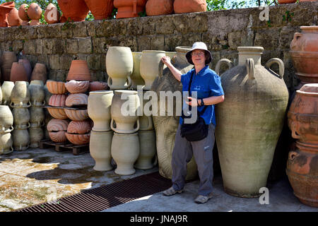 New gigantic terracotta pots Naples, Italy with woman visitor standing next to them Stock Photo