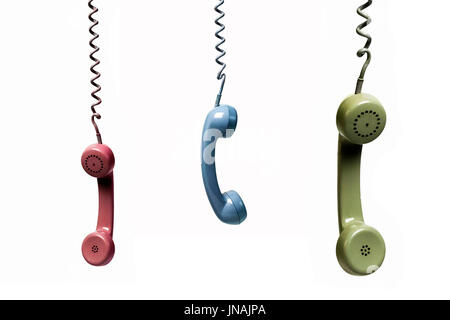 Three phones hanging from several colors isolated on a white background Stock Photo