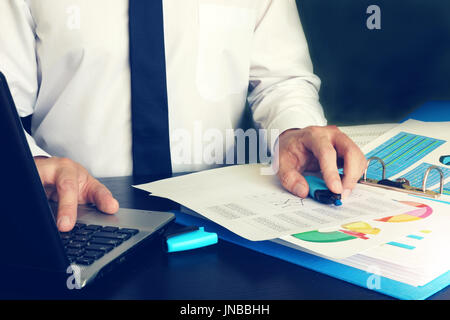 Working day of manager with laptop in office. Stock Photo