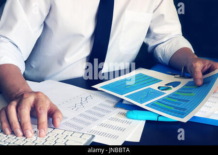 Businessman working with computer and financial business documents at office. Stock Photo