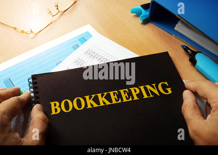 Bookkeeping written on a front of note. Stock Photo