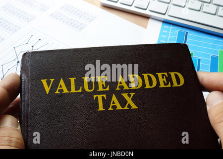 Value added tax VAT written on a front of book. Stock Photo