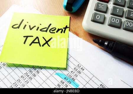 Stick with words dividend tax on a table. Stock Photo