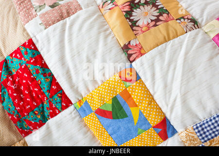 decoration, creation, art concept. bright eye-catching blanket made in patchwork teqnicue owerhelmed by colors, images of gerberas and arctotis conclu Stock Photo