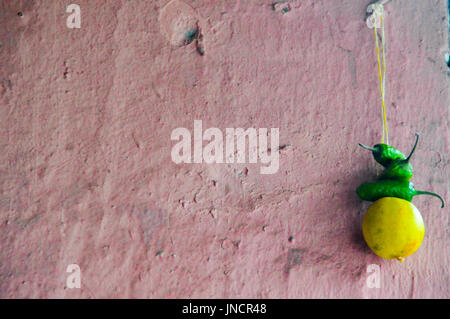 Lemon and chillies hanged in houses in Nepal and India as good luck charm and protection against the evil eye Stock Photo