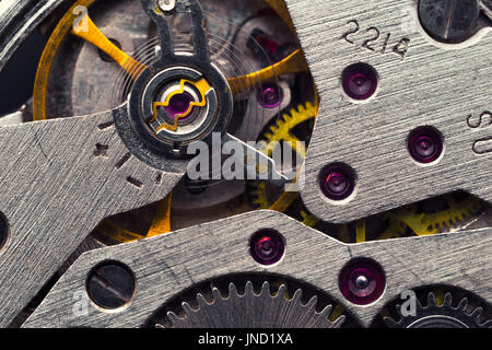 Old clock mechanism with gears and cogs. Macro photo; Abstract background; Closeup view Stock Photo