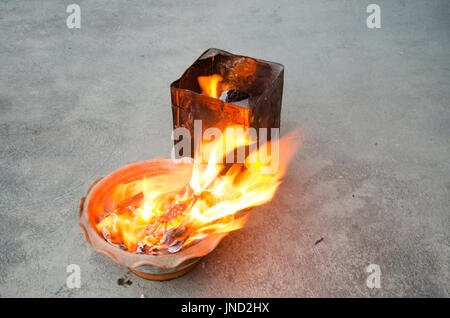People burn joss paper gold and silver paper for worship with paper made to resemble money and burned as sacrificial offering for pray to god and memo Stock Photo
