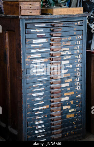 Black antique stack of printer tray drawers in colonial print shop Stock Photo