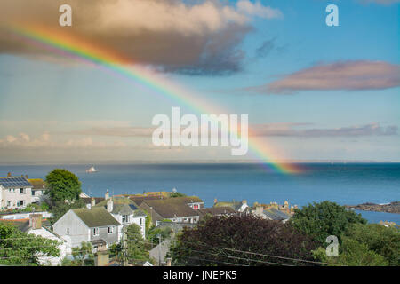 Mousehole, Cornwall, UK. 30th July 2017. UK Weather. After a sunny afternoon a sudden deluge brought a rainbow over Mousehole and the sea at Mounts Bay Credit: Simon Maycock/Alamy Live News Stock Photo