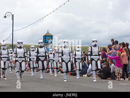 Swanage, Dorset, UK. 30th July, 2017. Visitors flock to Swanage to watch the procession parade, as part of Swanage Carnival week. The theme this year is Swanage Goes Global for participants to show the national dress or characteristics of their favourite country. Star Wars Stormtrooper characters marching past. Credit: Carolyn Jenkins/Alamy Live News Stock Photo