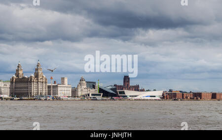 A multiple image panorama of the Liverpool waterfront captured from Seacombe promenade on the Wirral, seen under stormy clouds during the summer of 20 Stock Photo
