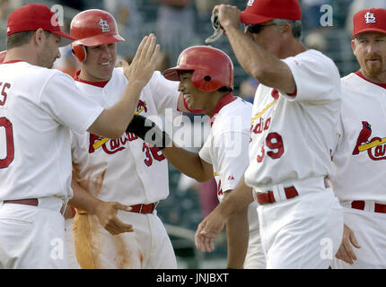 St. Louis Cardinals' So Taguchi is congratulated by third base