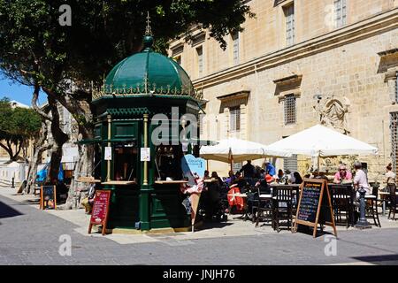 Pavement cafe in a small square along Republic Street aka Triq Ir Repubblika, Valletta, Malta, Europe. Stock Photo