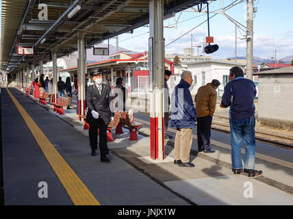 Tokyo, Japan - Jan 2, 2016. People waiting at the JR train station in Tokyo, Japan. Stock Photo