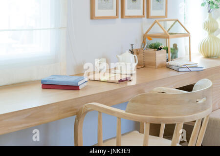Book and coffee cup and jar on wooden table with decoration in home. Read corner interior room concept. Stock Photo