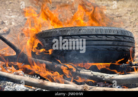 How to start a fire with old tires and branches. a set of 5 images Stock Photo