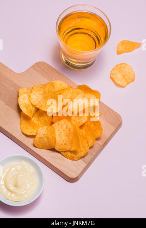 Concept of unhealthy food. Potato chips in a bowl and ketchup Stock Photo