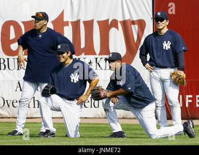 New York Yankees outfielder Johnny Damon (R) jumps on the pile as
