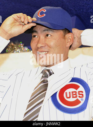 Japanese free agent outfielder Kosuke Fukudome, left, shows his new team  jersey with the Chicago Cubs manager Jim Hendry at Wrigley Field,  Wednesday, Dec. 19, 2007, in Chicago. (AP Photo/Nam Y. Huh