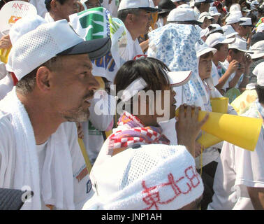 NISHINOMIYA, Japan - Farsad Darvish (L) and his wife Ikuyo (C), parents of  Tohoku High Schools ace Yu Darvish,who would later become pro club Nippon  Ham Fighters pitcher, root for their son